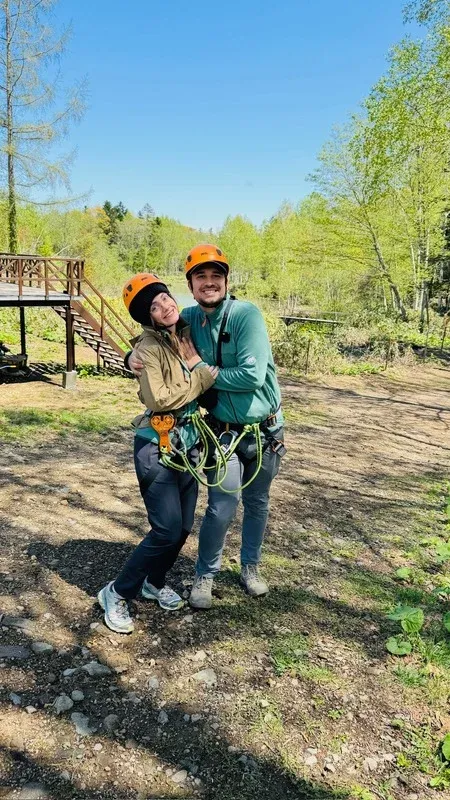 Morgan and Spencer in climbing harnesses