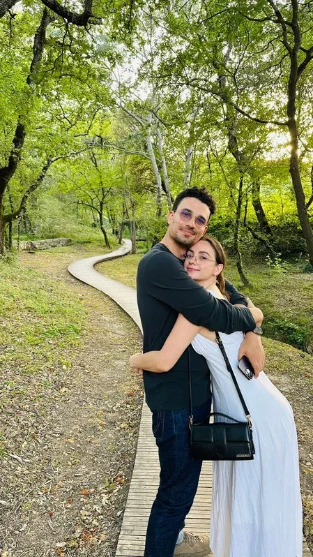 Morgan and Spencer hugging on a wooded path