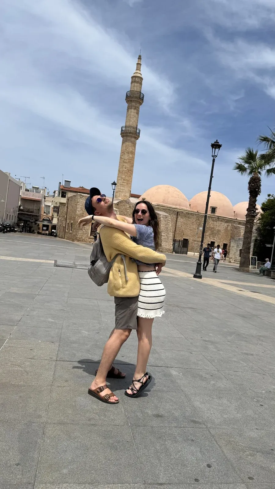 Morgan and Spencer embracing in a plaza