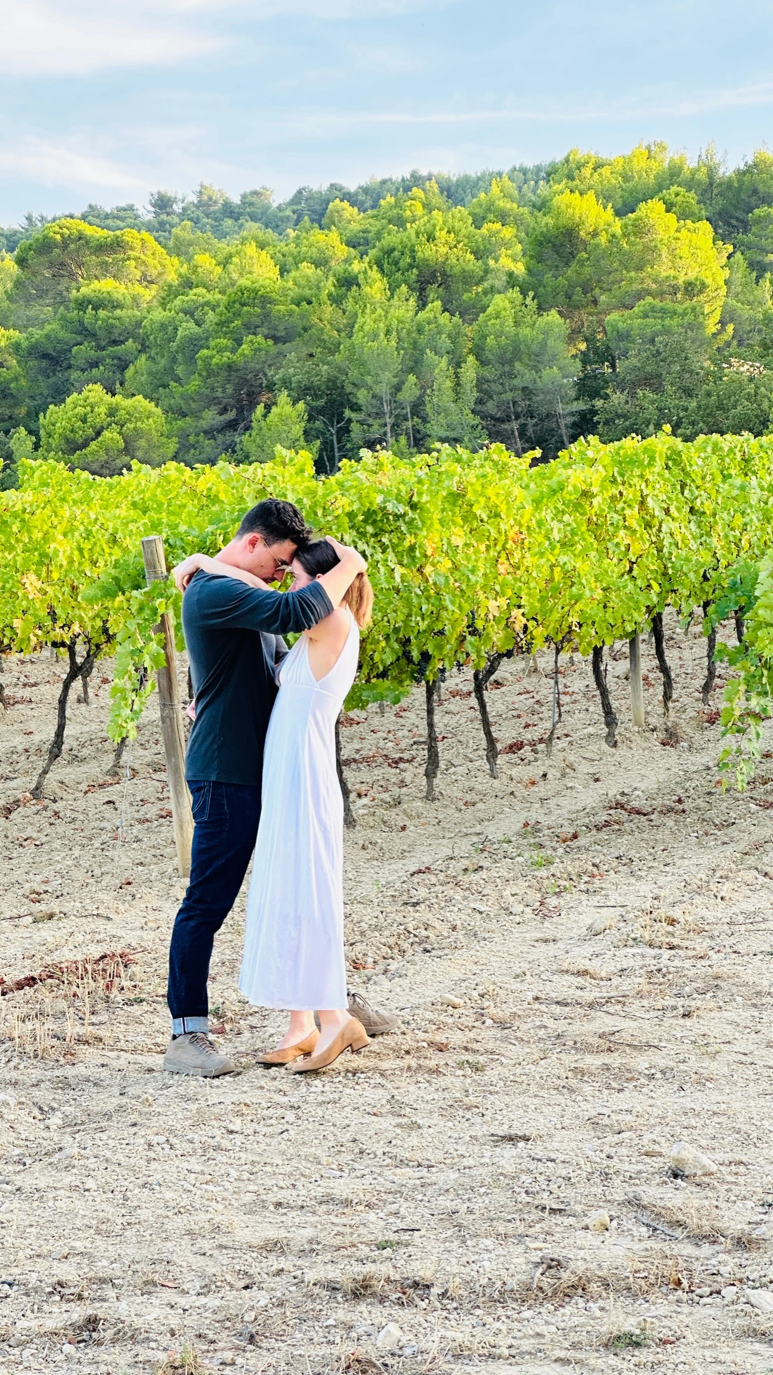 Morgan and Spencer forehead to forehead in a vineyard